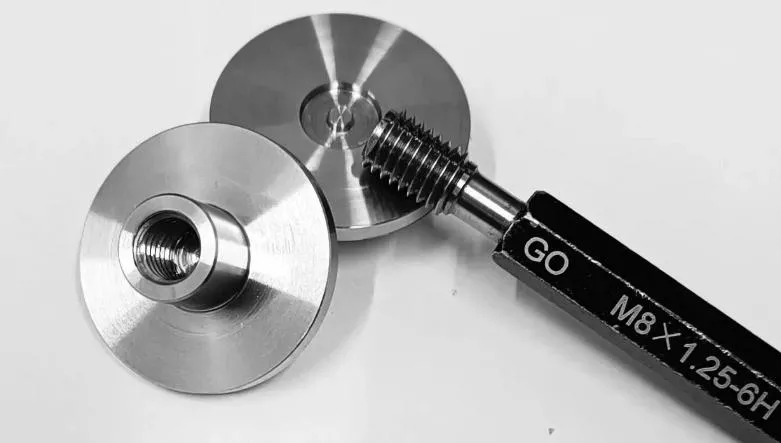 How to Measure Thread Size? 5 Precision CNC machined threaded components being inspected with thread gauges and measurement tools for thread accuracy verification.