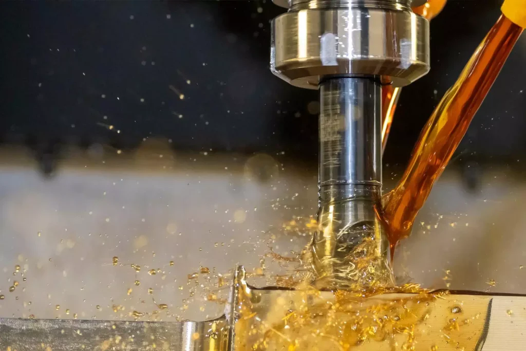 What Metals Can Be CNC Machined? 2 CNC metal machining showing cutting tool engagement, chip formation, and coolant at the cutting zone